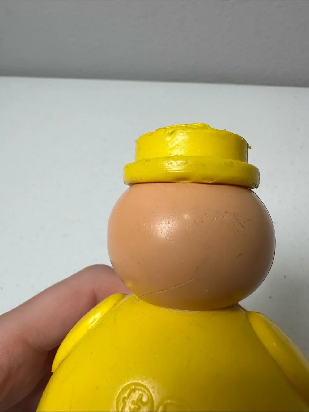 Fisher-Price Yellow Roly-Body Toy with Peach Face and Blue Base